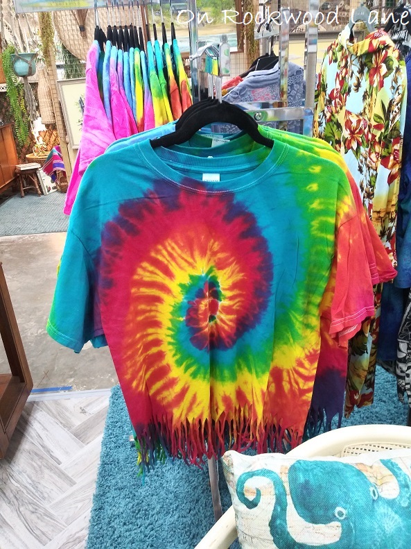 Rainbow colored tie dyed Gildan t-shirt with fringe on the bottom